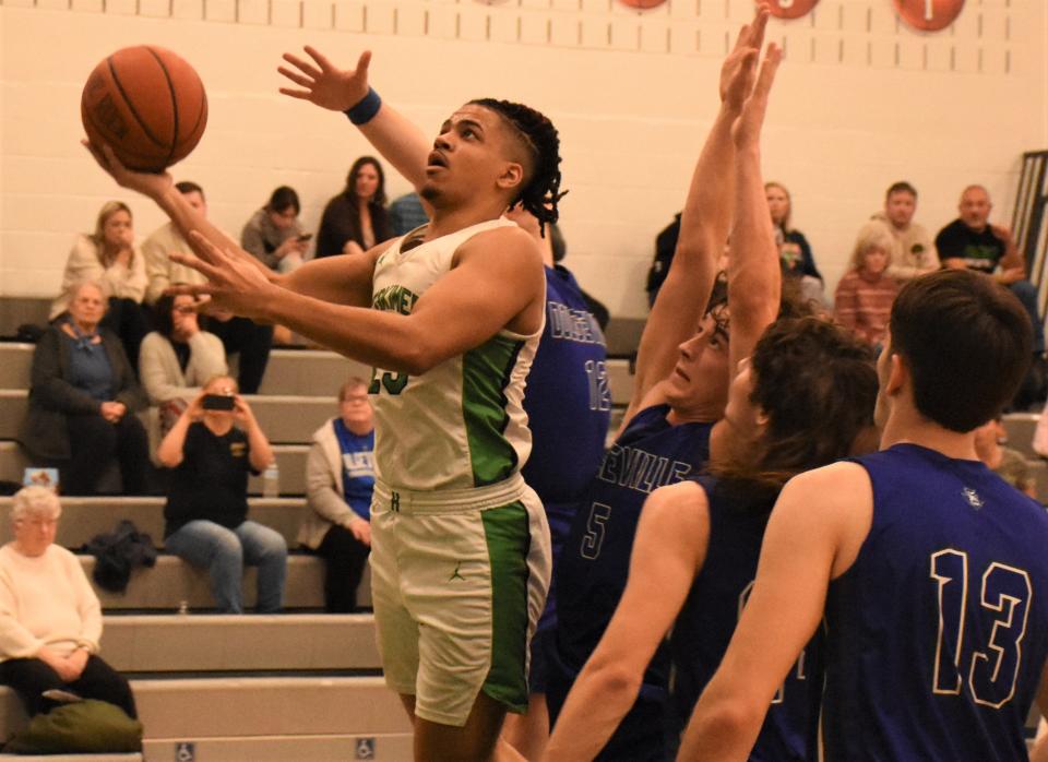 Herkimer Magician Dante Mollel lays the ball up for a basket in front of Dolgeville defenders Tuesday, Jan. 31, 2024, in Herkimer, New York.