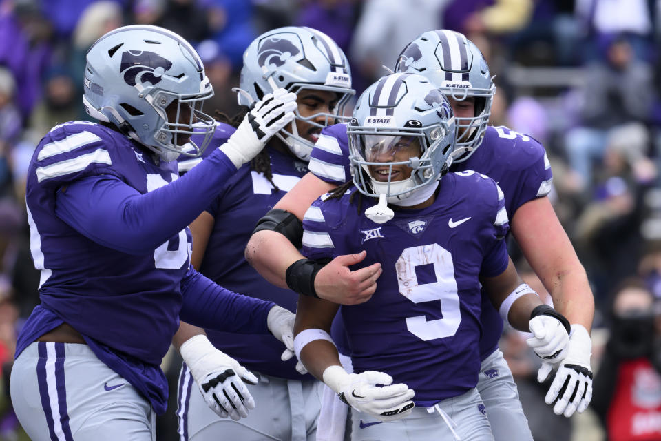 Kansas State running back Treshaun Ward (9) is congratulated after scoring a touchdown against Houston during the first half of an NCAA college football game in Manhattan, Kan., Saturday, Oct. 28, 2023. (AP Photo/Reed Hoffmann)