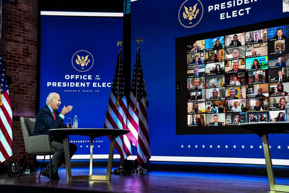 Joe Biden speaks to people on a video conference.