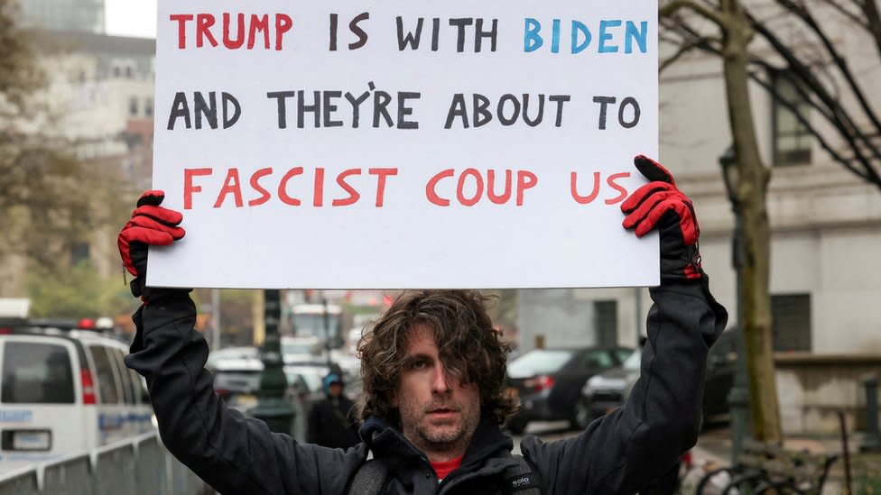 Max Azzarello holds a sign outside the Manhattan court on Thursday