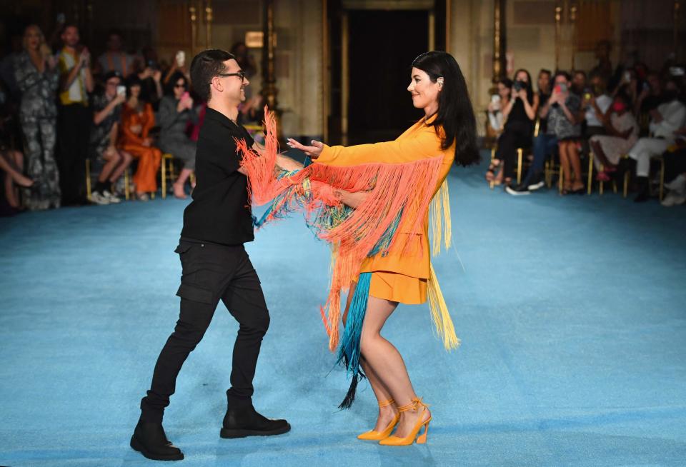 Designer Christian Siriano and Welsh singer Marina Diamandis, known mononymously as Marina, acknowledge the audience after the presentation of his Spring 2022 collection during New York Fashion Week on Sept. 7, 2021.