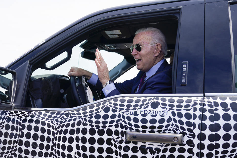 FILE - In this May 18, 2021 file photo, President Joe Biden stops to talk to the media as he drives a Ford F-150 Lightning truck at Ford Dearborn Development Center in Dearborn, Mich. On Friday, May 21, The Associated Press reported on stories circulating online incorrectly claiming Biden was caught fake driving a Ford F-150 Lightning truck during a visit to a Ford safety testing center Tuesday. (AP Photo/Evan Vucci, File)