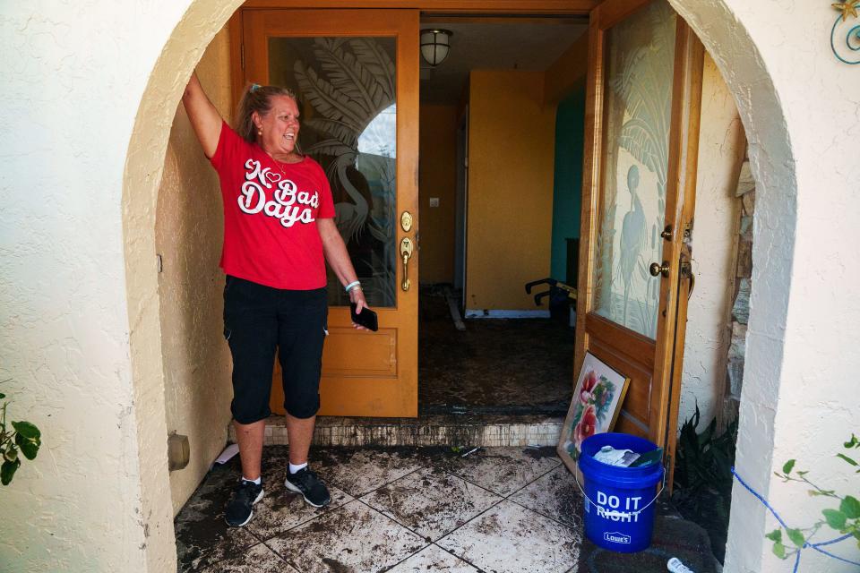 Oct 5, 2022; Fort Myers, FL, USA; Peggy Zachritz shows the area of her front porch where she and her husband Bruce floated in rising waters after Hurricane Ian caused major flooding in her neighborhood.. Mandatory Credit: Josh Morgan-USA TODAY