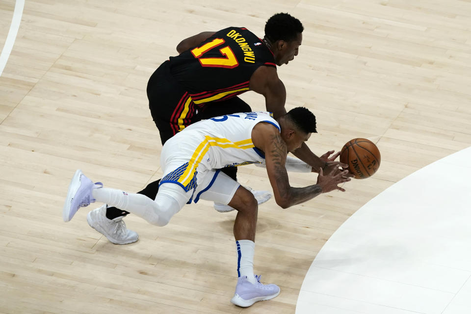 Atlanta Hawks forward Onyeka Okongwu (17) steals the ball from Golden State Warriors forward Kent Bazemore (26) in the second half of an NBA basketball game Sunday, April 4, 2021, in Atlanta. (AP Photo/John Bazemore)