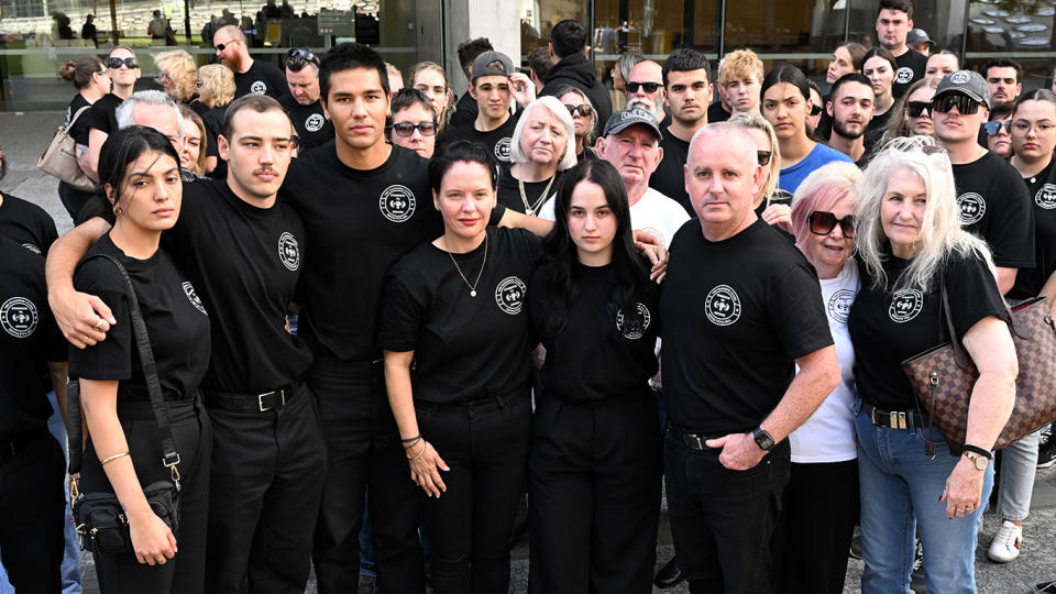 Kylie and Kent Payne, parents of victim Harrison Payne, are seen with supporters outside the Brisbane District Court on Monday.