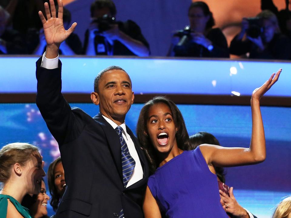 Barack Obama waves on stage with Malia Obama after accepting the nomination during the final day of the Democratic National Convention at Time Warner Cable Arena on September 6, 2012 in Charlotte, North Carolina