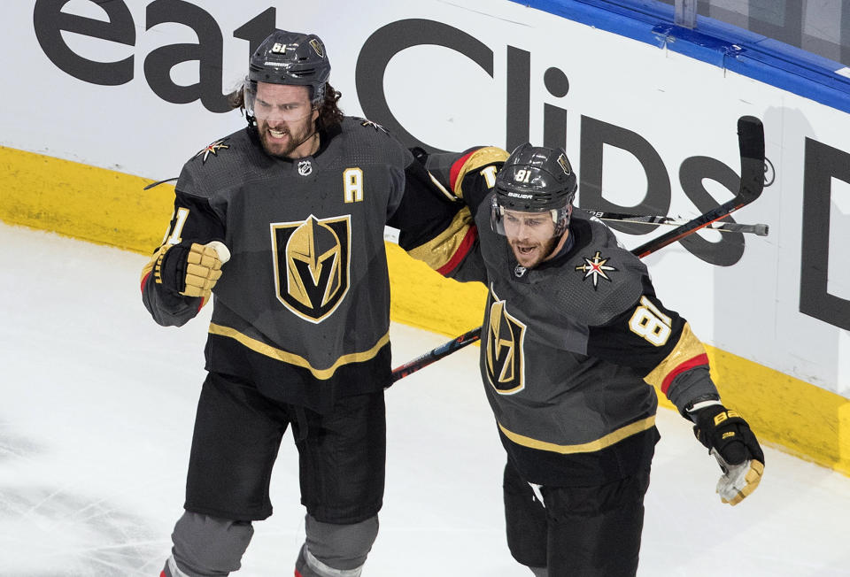 Vegas Golden Knights' Mark Stone (61) and Jonathan Marchessault (81) celebrate a goal against the Chicago Blackhawks during the second period of a first-round NHL Stanley Cup playoff hockey series in Edmonton, Alberta, Thursday, Aug. 13, 2020. (Jason Franson/The Canadian Press via AP