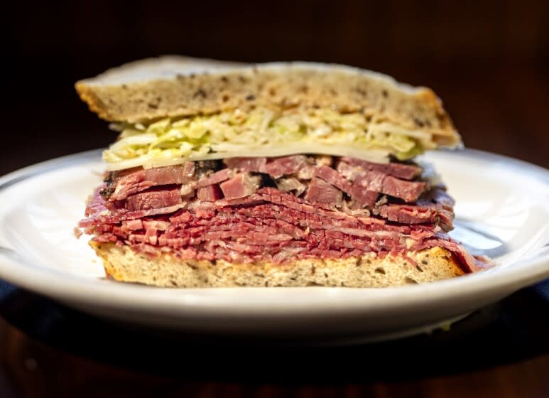 LOS ANGELES, CA - October 18: At Langer's Deli, the #54, a pastrami and corned beef combo sandwich, dressed in the style of the #19, with Swiss cheese and cole slaw and Russian style dressing, photographed in Los Angeles, CA, Langer's Deli, Monday, Oct. 18, 2021. (Jay L. Clendenin / Los Angeles Times)