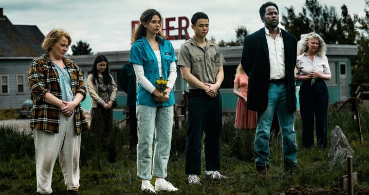 People stand outside a diner in From season 2.