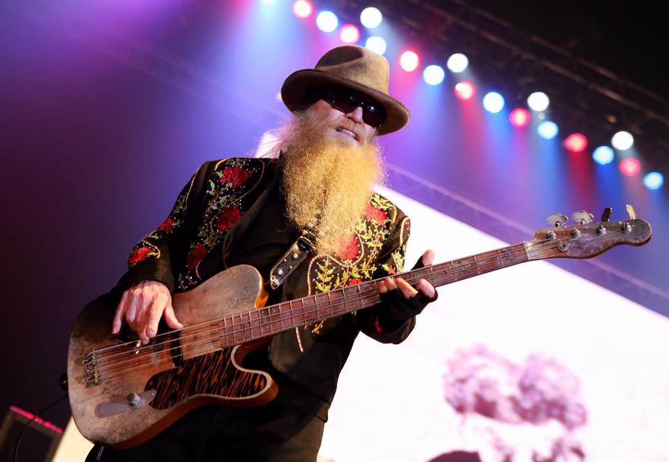 Dusty Hill holding a bass guitar during a performance on stage