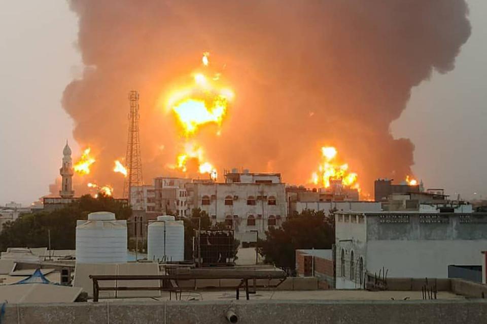 A handout picture obtained from Yemen's Huthi Ansarullah Media Center shows a huge column of fire erupting following reported strikes in the Yemeni rebel-held port city of Hodeida opn July 20 (ANSARULLAH MEDIA CENTRE/AFP via)