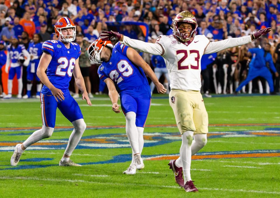 Florida Gators place kicker Trey Smack (29) reacts to a missed field goal in the final seconds of the first half as Florida State Seminoles defensive back Fentrell Cypress II (23) signals a miss at Steve Spurrier Field at Ben Hill Griffin Stadium in Gainesville, FL on Saturday, November 25, 2023. [Doug Engle/Gainesville Sun]