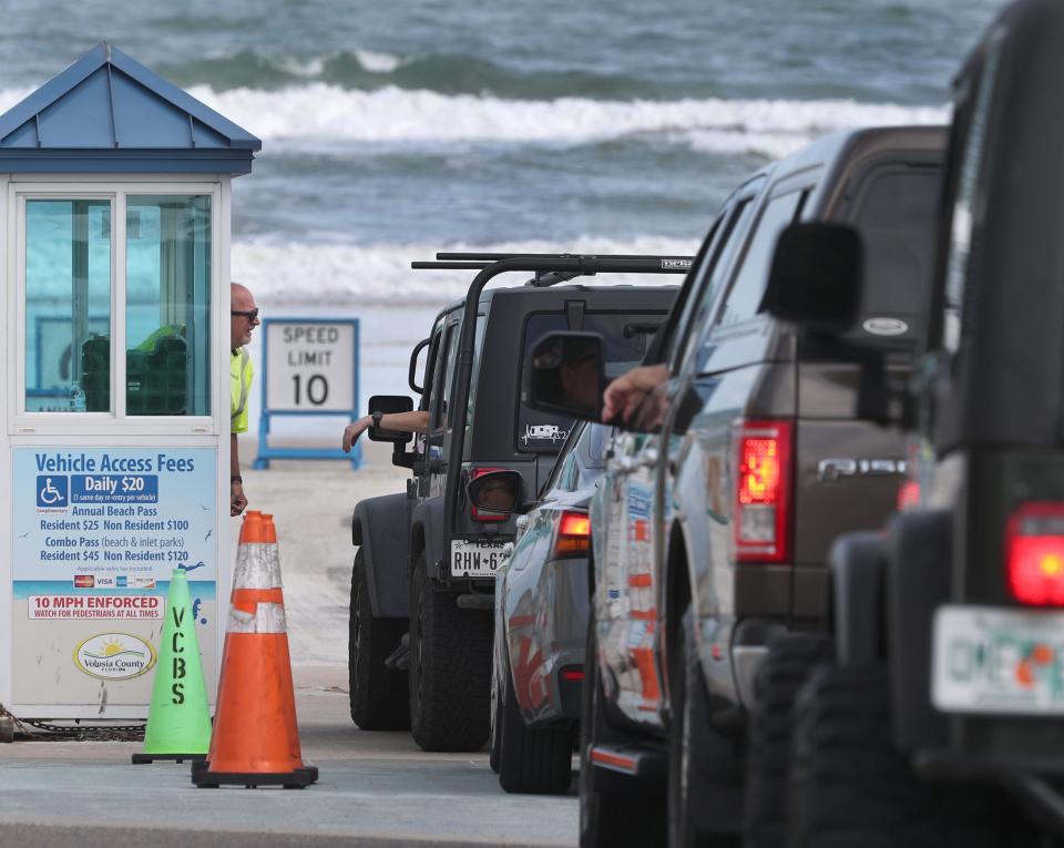 Drivers wait to get on the beach at the International Speedway Boulevard beach ramp on January 24, 2023.