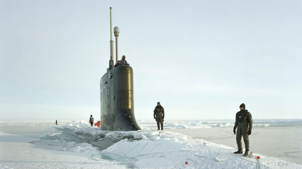 Ship divers are pictured atop the USS New Hampshire as it crests through ice in arctic waters in 2011, from Lê's "Events Ashore" series. - Courtesy the artist/Marian Goodman Gallery