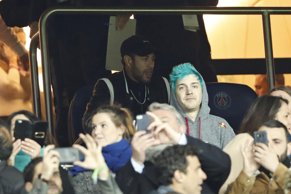 PSG forward Neymar, top, watches in the tribune the Champions League round of 16, 2nd leg, soccer match between Paris Saint Germain and Manchester United at the Parc des Princes stadium in Paris, France, Wednesday, March. 6, 2019. (AP Photo/Thibault Camus)