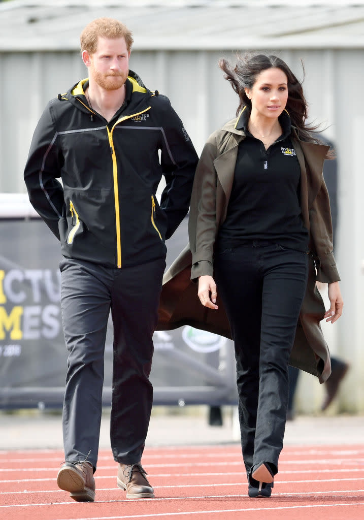 <p>For the UK team trials ahead of the Invictus Games, Meghan Markle recycled her go-to jeans by Mother Denim. She finished the look with an official polo and a spring-ready trench by Babaton for Aritizia. <em>[Photo: Getty]</em> </p>