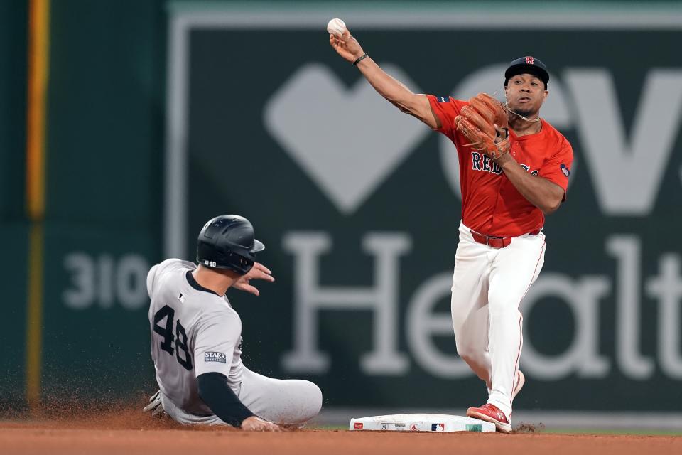 New York Yankees' Anthony Rizzo (48) is forced out at second base as Boston Red Sox second baseman Enmanuel Valdez turns the double play on Gleyber Torres during the fourth inning of a baseball game Friday, June 14, 2024, in Boston. (AP Photo/Michael Dwyer)