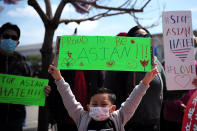 <p>A small boy holds up a "Proud To Be Asian" sign at a rally in Oakland on April 3.</p>