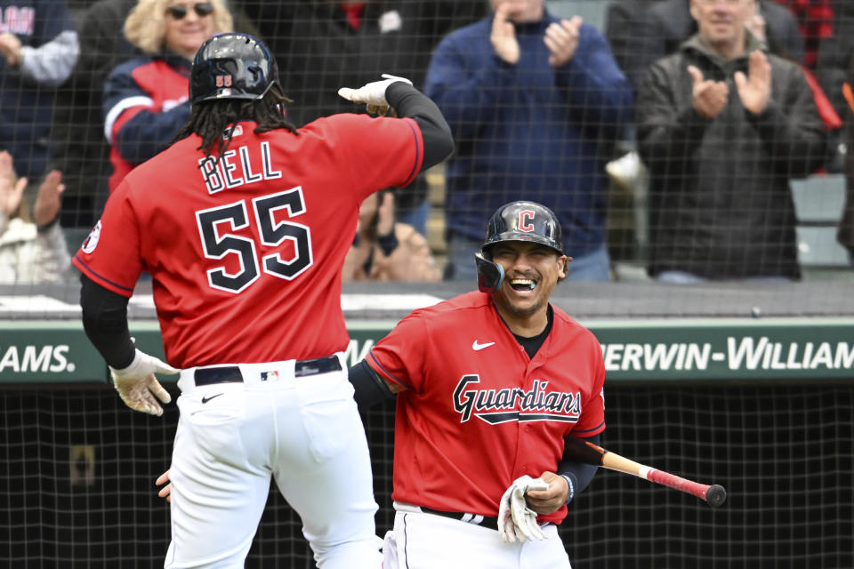 Cleveland Guardians' Josh Bell (55) and Josh Naylor celebrate a solo home run hit by Bell off Miami Marlins starting pitcher Jesús Luzardo during the third inning of a baseball game, Sunday, April 23, 2023, in Cleveland. (AP Photo/Nick Cammett)