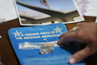 A piece of the USS Arizona Memorial, given to Teri Mann Whyatt as a child, is displayed at her home Wednesday, July 14, 2021, in Newcastle, Wash. Whyatt's uncle, William Edward Mann, died on the USS Arizona during the bombing of Pearl Harbor. In recent years, the U.S. military has taken advantage of advances in DNA technology to identify the remains of hundreds of sailors and Marines who died in the 1941 bombing of Pearl Harbor and has sent them home to their families across the country for burial. The remains of 85 unknowns from the USS Arizona, which lost more men during the attack than any other ship, haven't received this treatment, however. (AP Photo/Elaine Thompson)