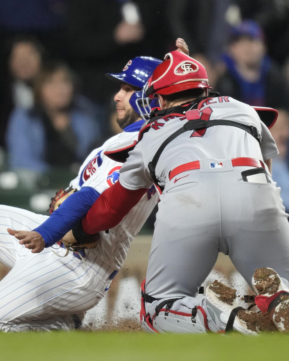 St. Louis Cardinals catcher Andrew Knizner tags out Chicago Cubs pinch-runner Nick Madrigal at home during the fifth inning of a baseball game on Monday, May 8, 2023, in Chicago. (AP Photo/Charles Rex Arbogast)