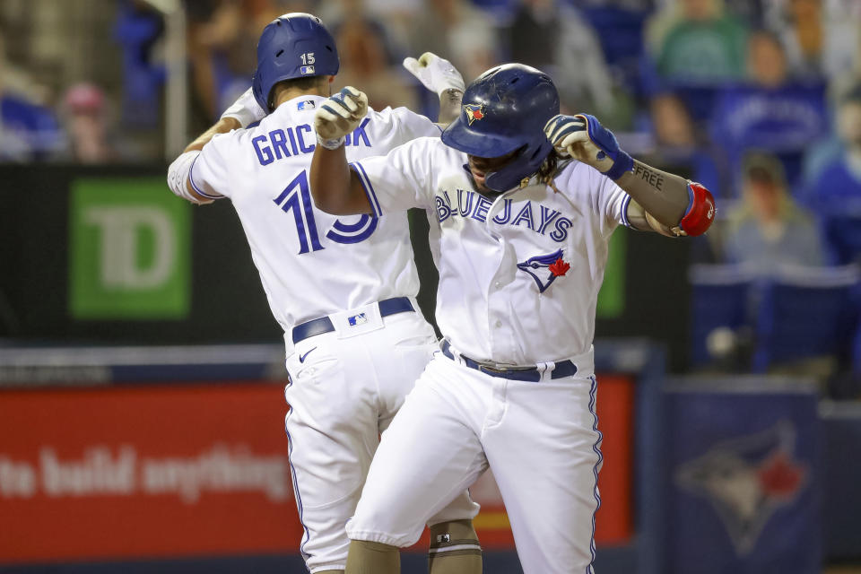 Toronto Blue Jays' Vladimir Guerrero Jr., right, celebrates his solo home run against the Philadelphia Phillies with Randal Grichuk during the sixth inning of a baseball game Friday, May 14, 2021, in Dunedin, Fla. (AP Photo/Mike Carlson)