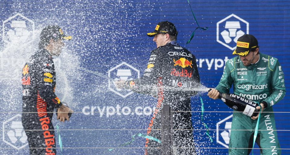 From left to right: Red Bull Racing's Mexican driver Sergio Perez, who placed second, Red Bull Racing's Dutch driver Max Verstappen, who placed first, and Aston Martin's Spanish driver Fernando Alonso, who placed third, celebrate on the podium the Formula One Miami Grand Prix at the Miami International Autodrome on Sunday, May 7, 2023, in Miami Gardens, Fla.(Matias J. Ocner/Miami Herald via AP)