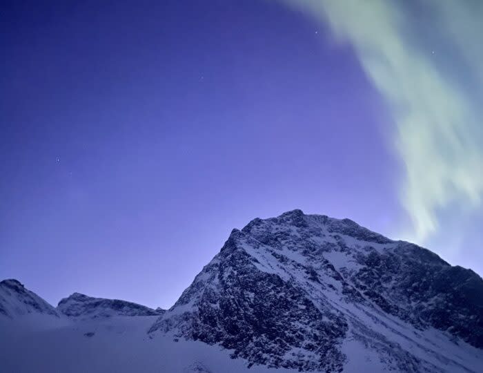 The aurora borealis above the Tarfala Hut; (photo/Drew Zieff)