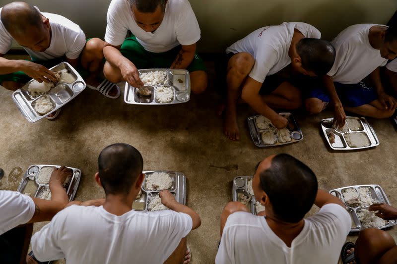 Drug rehab patients eat lunch at the Mega Drug Abuse Treatment and Rehabilitation Center, in Nueva Ecija province, north of Manila