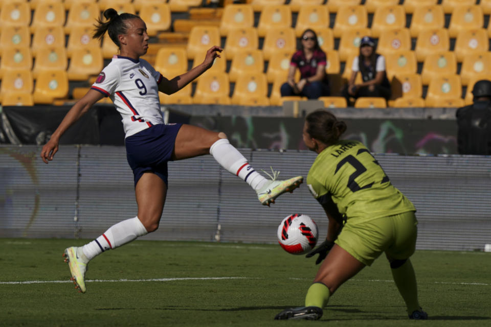 United States' Mallory Pugh, left, and Haiti's goalkeeper Lara Larco battle for the ball during a CONCACAF Women's Championship soccer match in Monterrey, Mexico, Monday, July 4, 2022. (AP Photo/Fernando Llano)