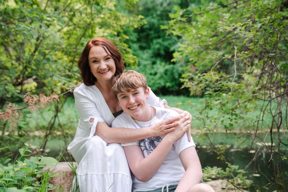 Susan Williams, executive director of the Transformation Project, embraces her son Wyatt Williams during a family portrait session.