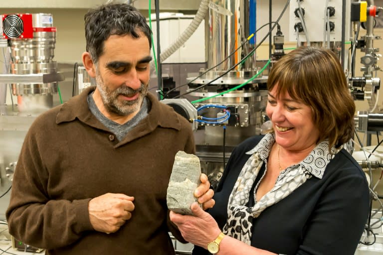 University of Wollongong research professors Allen Nutman (L) and Vickie Bennett hold a rock specimen containing 3.7-billion-year-old stromatolites from Greenland