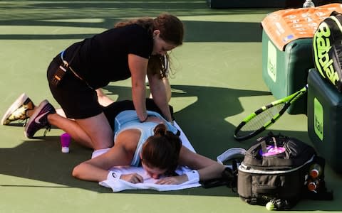 Konta receives treatment during an injury timeout - Credit: Getty Images