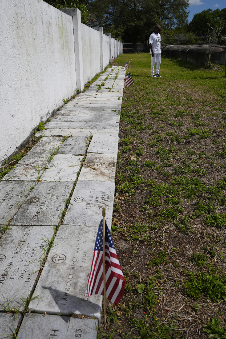 The tomb markers of veterans line a wall at the Lincoln Memorial Park Cemetery, Monday, Feb. 26, 2024, in the Brownsville neighborhood of Miami. The cemetery holds the remains of many Black veterans from the Civil War to the Iraq War. (AP Photo/Marta Lavandier)
