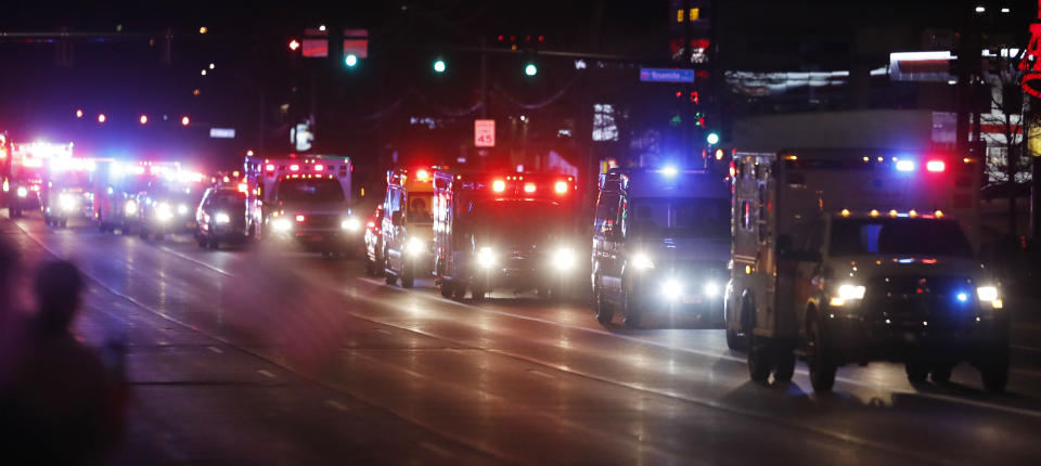 A procession of emergency vehicles follows the ambulance carrying the body of retired paramedic Paul Cary after its arrival from New York late Sunday, May 3, 2020, in Denver. Cary died from coronavirus after volunteering to help combat the pandemic in New York City. (AP Photo/David Zalubowski)