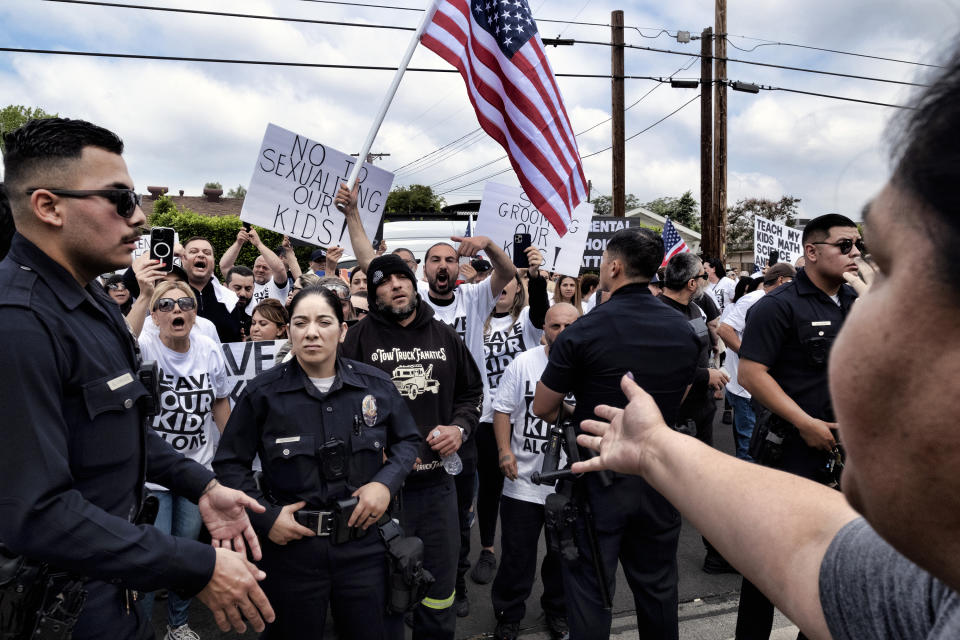 Protestors face off as Los Angeles police officers separate them at the Saticoy Elementary School in the North Hollywood section of Los Angeles on Friday, June 2, 2023. Police officers separated groups of protesters and counter-protesters outside the Los Angeles elementary school that has become a flashpoint for Pride month events across California. (AP Photo/Richard Vogel)