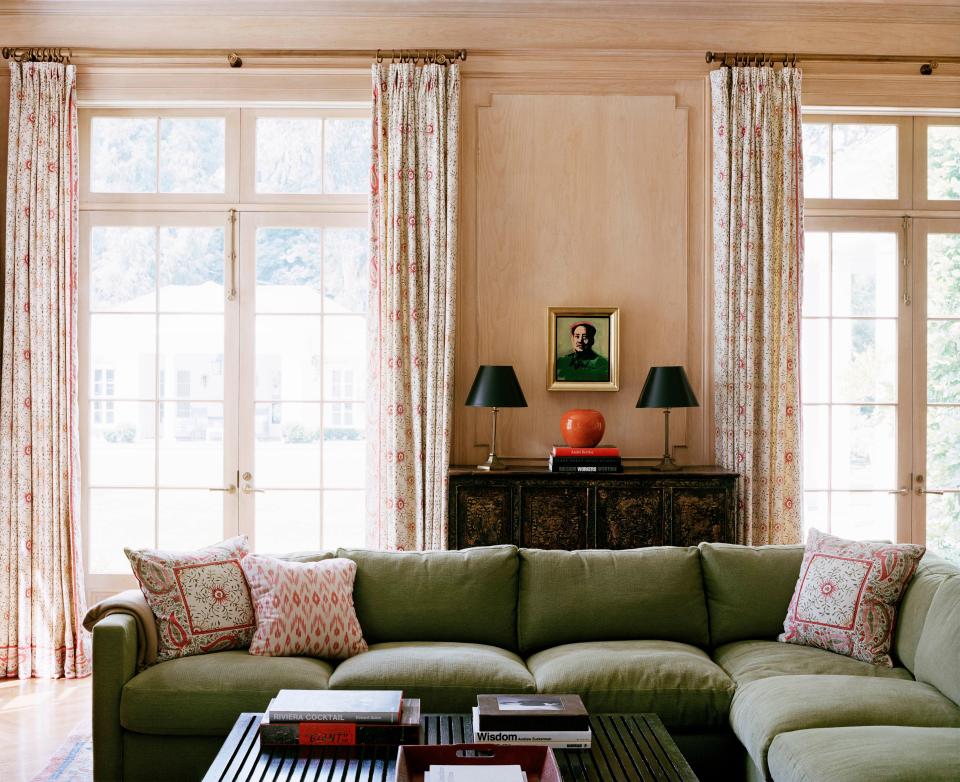 In the pine-paneled family room, an Andy Warhol painting hangs above a 19th-century Chinese chest and bowl.