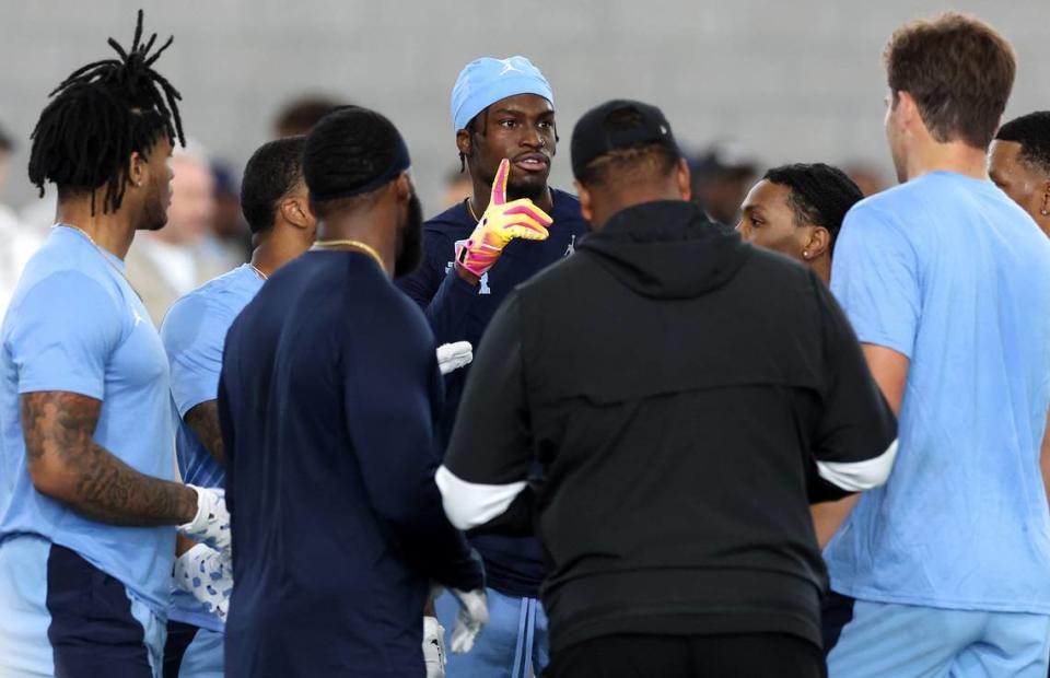 Wide receiver Tez Walker, center, makes a point during a brief huddle at the Carolina Football Pro Day at UNC Chapel Hill’s Koman Indoor Practice Facility on Thursday, March 28, 2024. JEFF SINER/jsiner@charlotteobserver.com