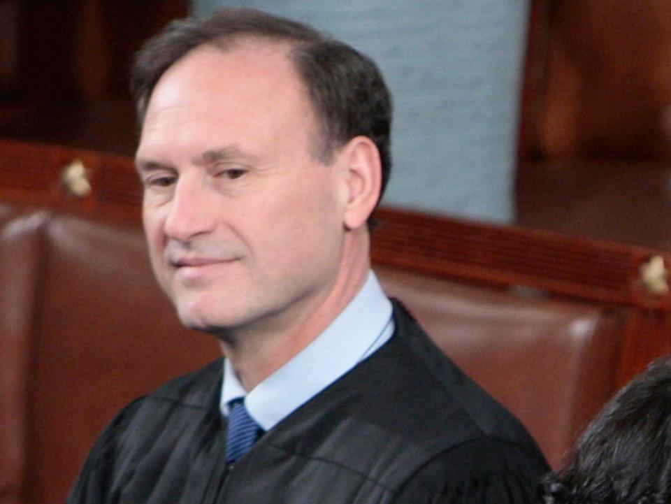 Supreme Court Justice Samuel Alito, left, and Sonia Sotomayor, center, are seen on Capitol Hill in Washington, prior to President Barack Obama's State of the Union address.