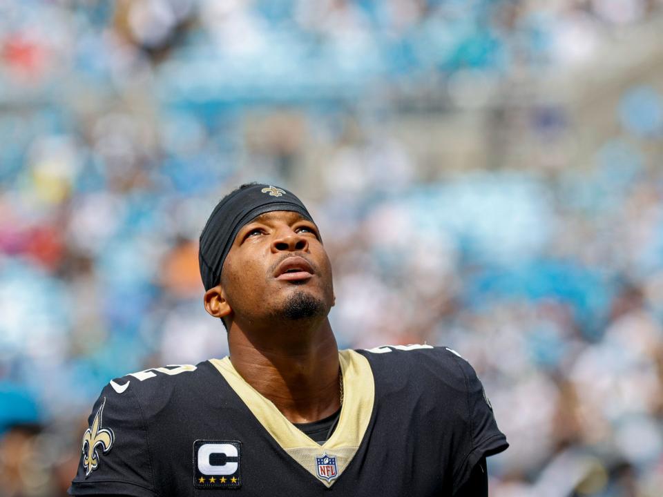 Jameis Winston stands on the sideline before a game against the Carolina Panthers.