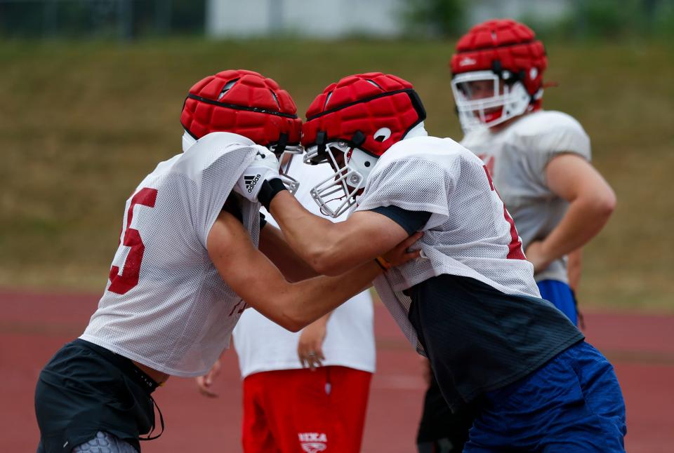 Nixa High School freshman Jackson Cantwell (right) runs drills during football practice on Tuesday, July 12, 2022. Cantwell is 6-foot-8 and a multi-sport athlete and also scored a 33 on the ACT.