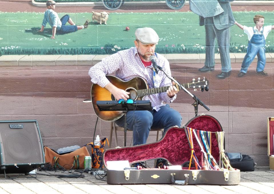 Eric Nassau performs in front of the Great American Crossroads mural in Millennium Park during the Bucyrus Area Chamber of Commerce’s May First Friday event in 2023. This year his performance is planned for June 7.