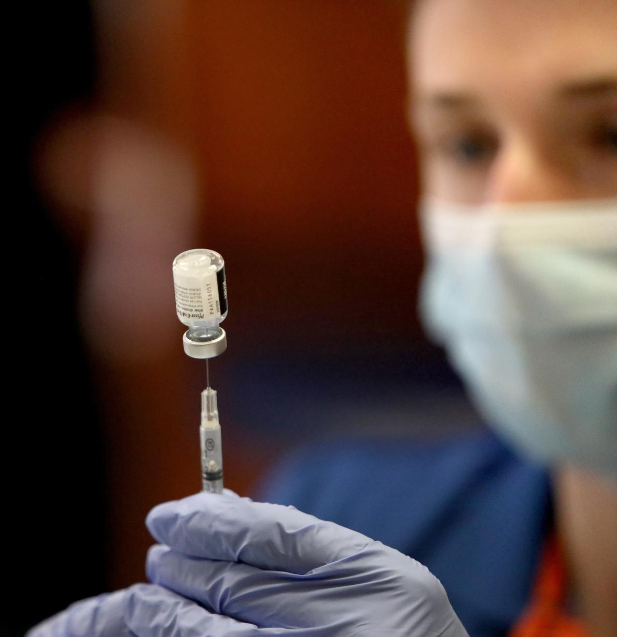 UF College of Pharmacy students and faculty draw out doses of the Pfizer COVID-19 vaccine during a mass vaccination event held at Ben Hill Griffin Stadium on Feb. 5.