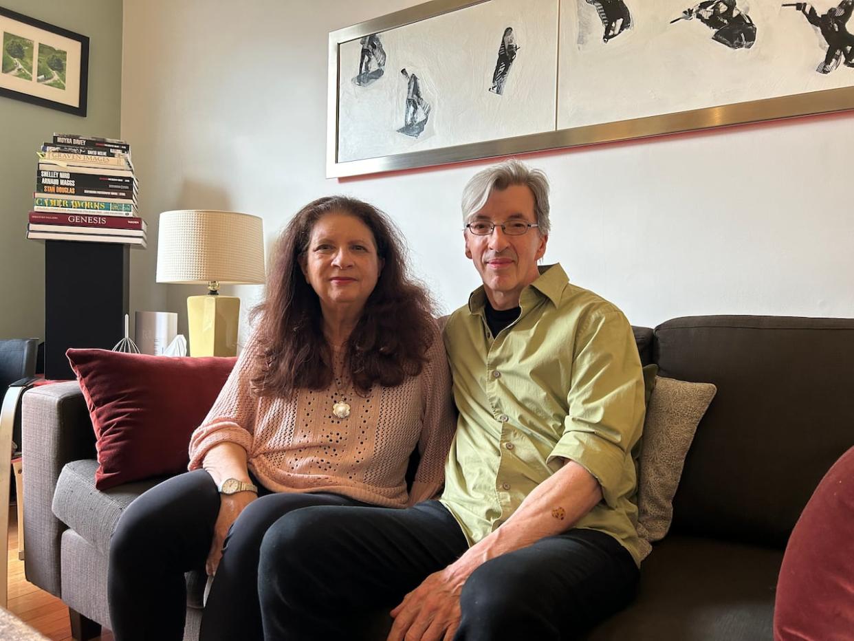 Martha Johnson and Mark Gane, wife and husband and band members of Martha and the Muffins, are pictured here in their home in Toronto. They released a new song, Slow Emotion, this week to raise awareness of Parkinson's disease. Johnson has had the disease for 23 years.   (Helen Bagshaw/CBC - image credit)