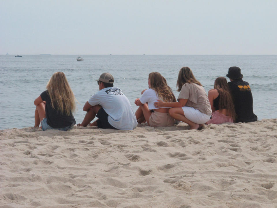 Friends of Keith Pinto gather at the beach.