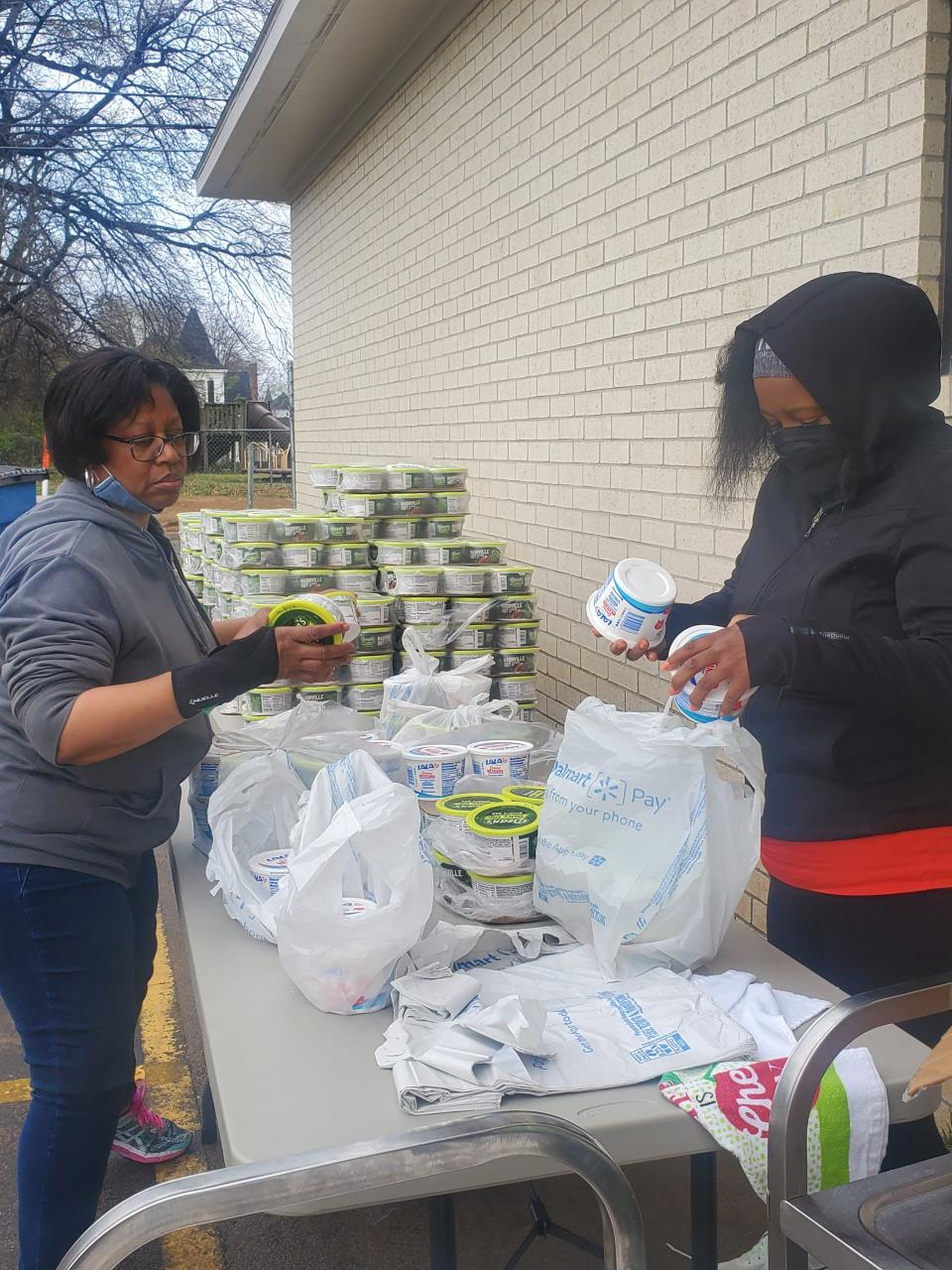 Volunteers pack food into bags during Mission United Methodist Church's first USDA commodities distribution, April 2, 2022.