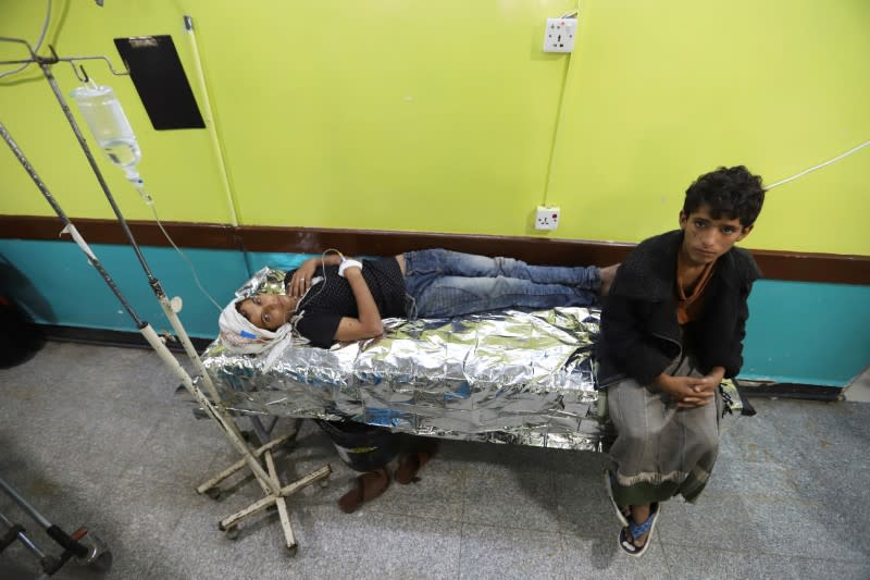 Boy lies on a stretcher as he recuperates from dengue fever at a hospital in Hodeidah