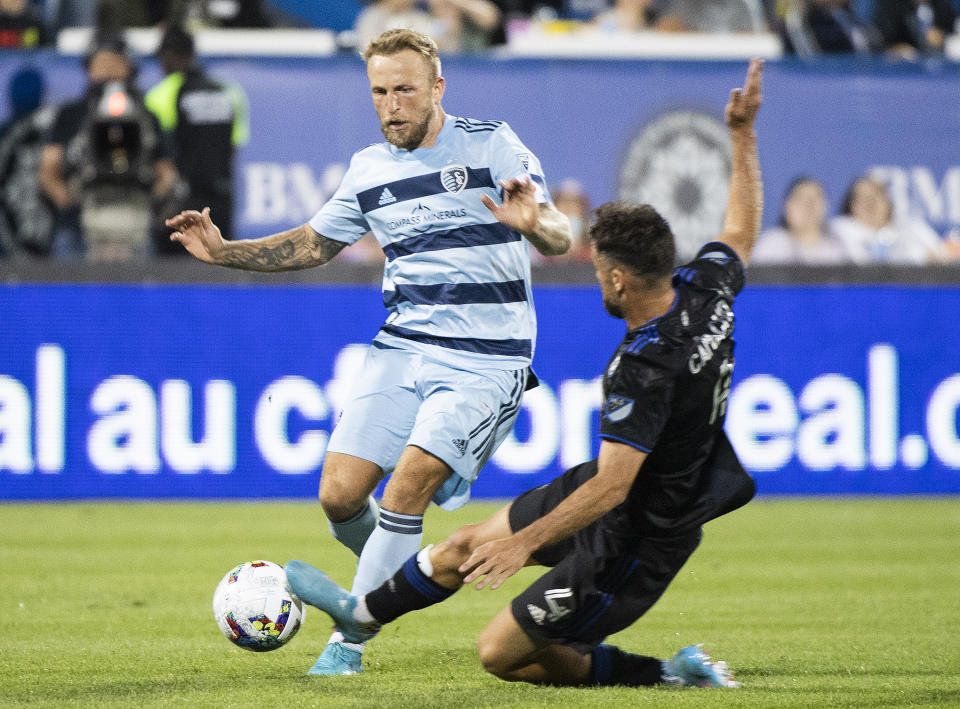 CF Montreal's Rudy Camacho, right, challenges Sporting Kansas City's Johnny Russell during the second half of an MLS soccer match Saturday, July 9, 2022, in Montreal. (Graham Hughes/The Canadian Press via AP)