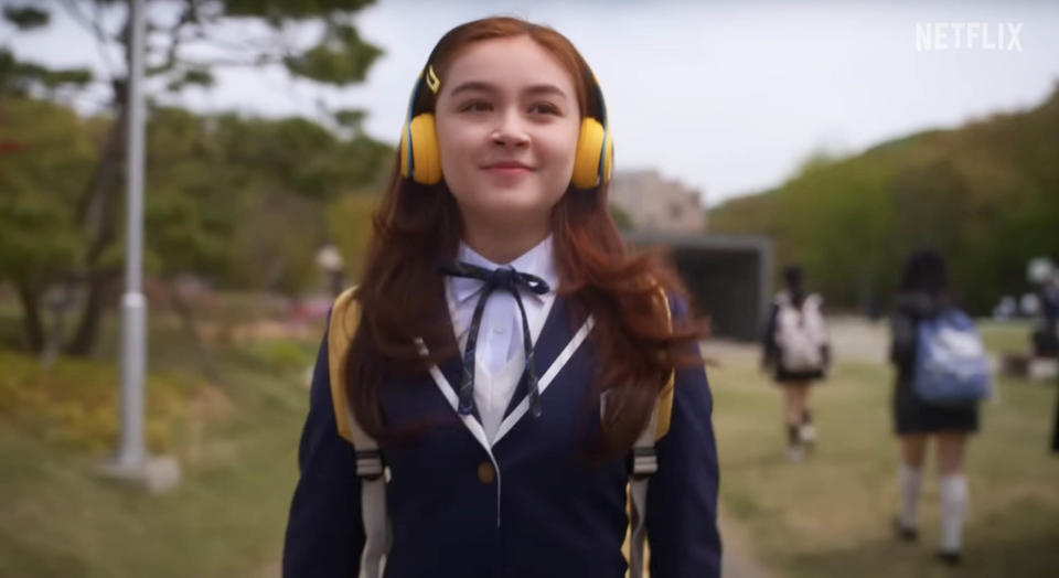 Kitty listens to music as she walks on the school campus
