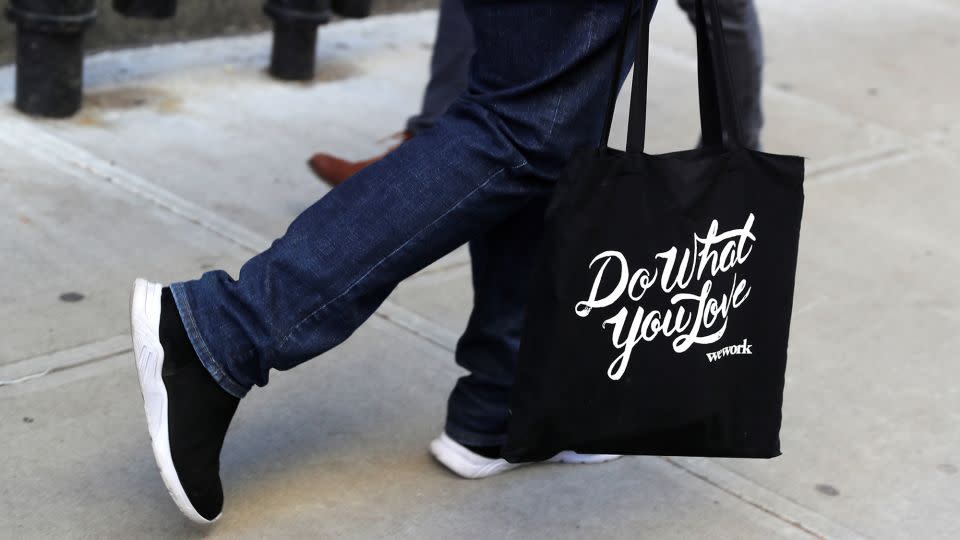 A laid-off WeWork employee carries a bag as he departs the WeWork corporate headquarters in Manhattan, New York, on November 21, 2019. - Mike Segar/Reuters